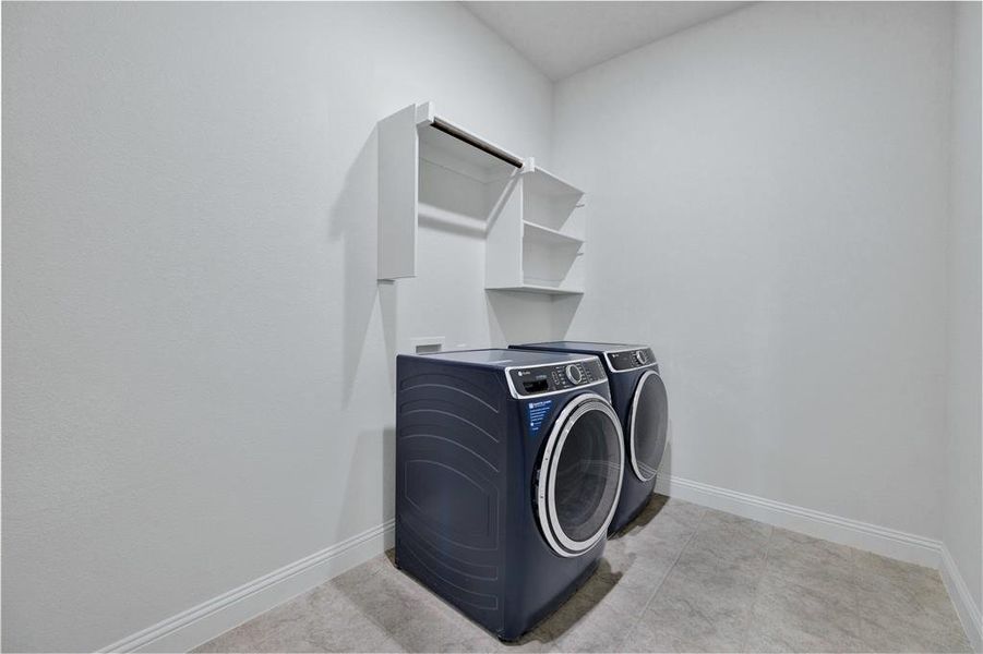 Laundry area with baseboards and washing machine and dryer