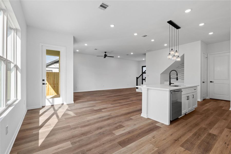 Bright and open living area filled with natural light, seamlessly connecting to the kitchen for everyday living and entertaining