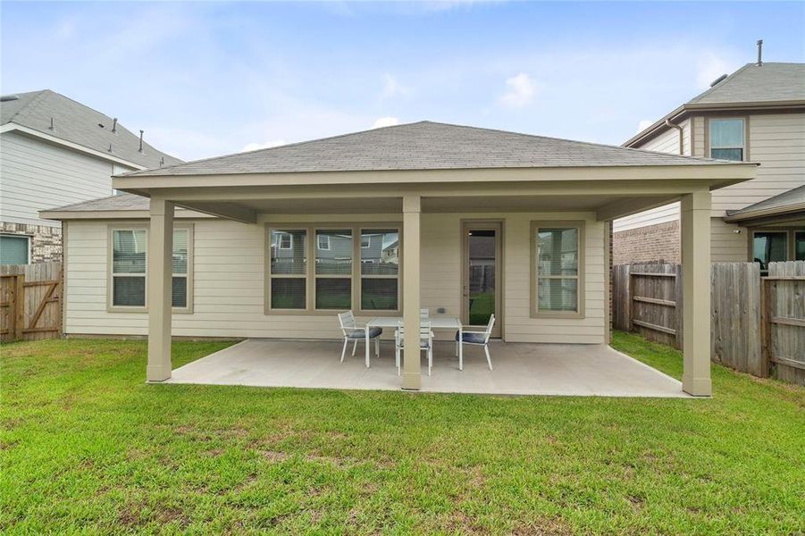 Come and see this spacious backyard with its beautiful covered patio. There is plenty of room for the kids to play and adults to relax!