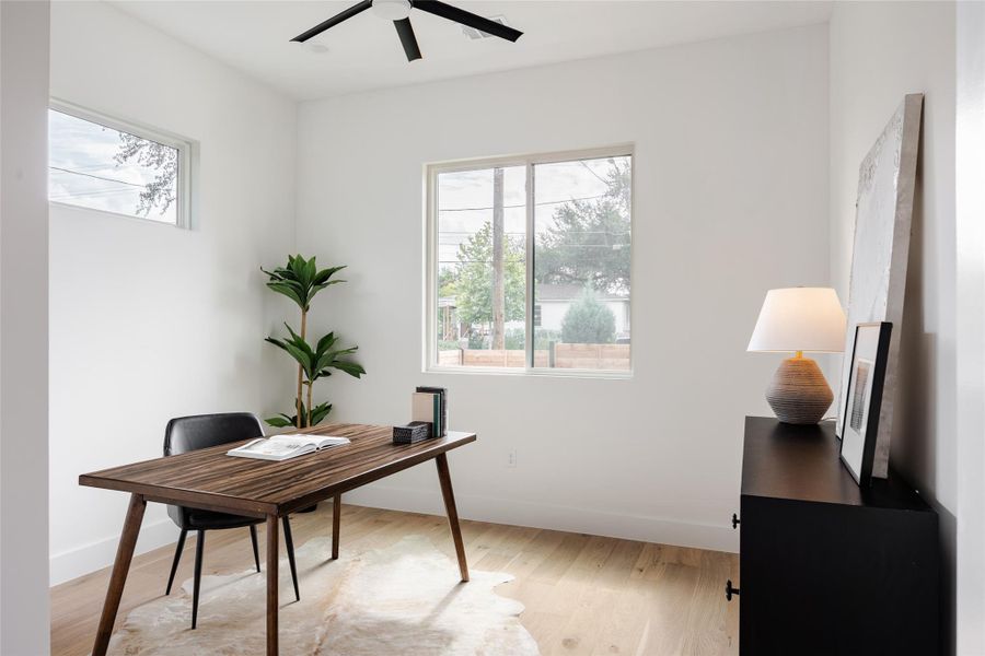 This versatile flex space, perfect for a bedroom, office, or art studio, is enhanced by a ceiling fan and warm-toned flooring, creating an inviting atmosphere for any purpose.