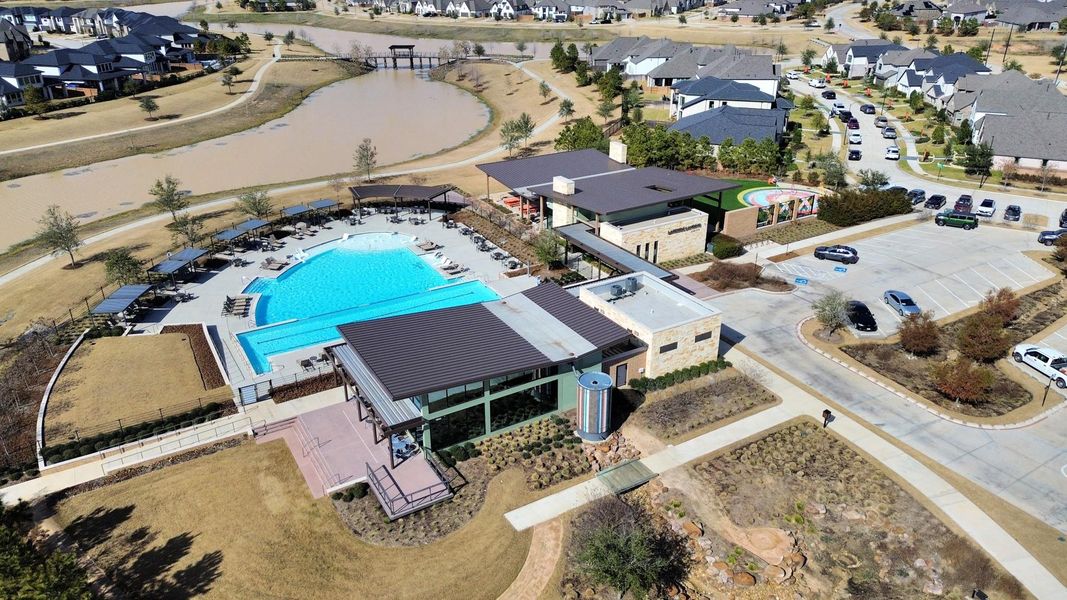 Aerial view of neighborhood pool, clubhouse, and recreation areas.