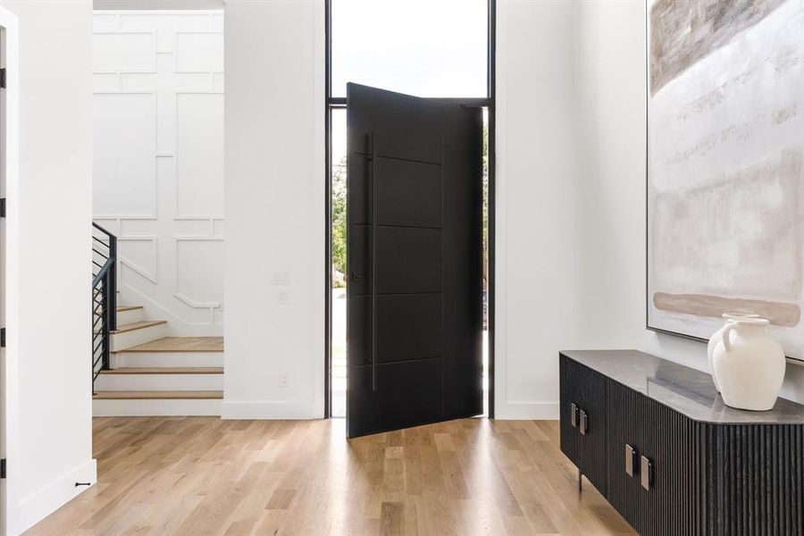 Entryway featuring light wood finished floors and stairway Entryway featuring light wood finished floors and stairway