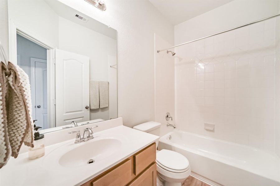 Guests will love this clean and crisp full bathroom, featuring a tub and shower combination with a neutral tile surround, along with a vanity that boasts chrome finishes and maple cabinetry. Guests will love this clean and crisp full bathroom, featuring a tub and shower combination with a neutral tile surround, along with a vanity that boasts chrome finishes and maple cabinetry.
