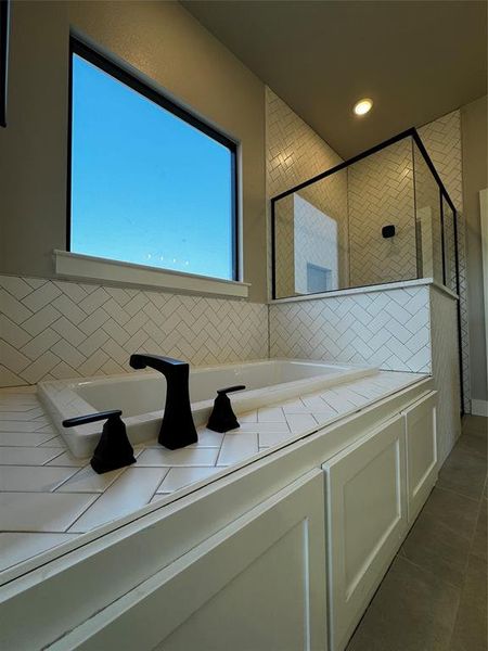 Bathroom with separate shower and tub and tile patterned floors