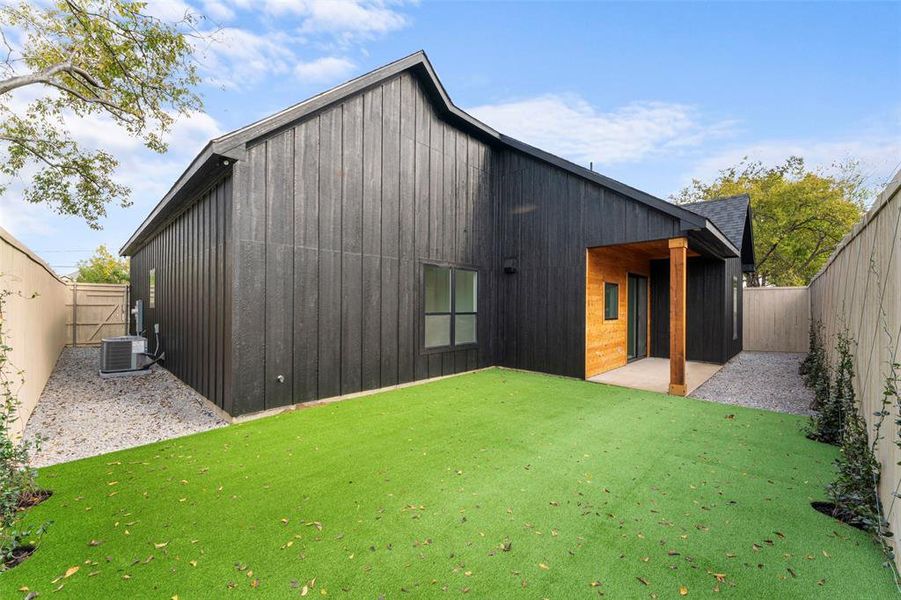 Rear view of property with a fenced backyard and a patio area