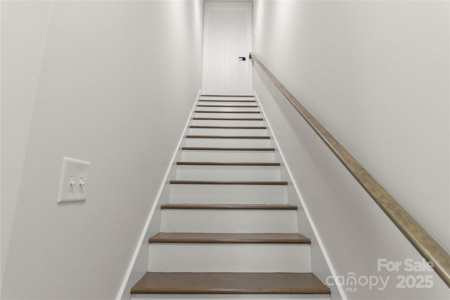 Stairway leading to bonus room over garage