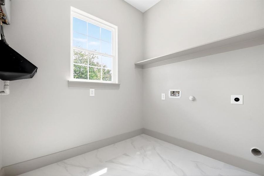 Laundry room featuring hookup for an electric dryer, gas dryer hookup, hookup for a washing machine, and light marble finish flooring Laundry room featuring hookup for an electric dryer, gas dryer hookup, hookup for a washing machine, and light marble finish flooring