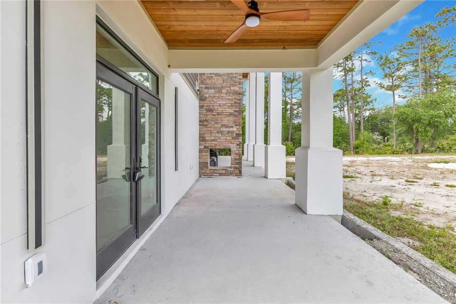 Porch off the primary bedroom with double sided wood burning fireplace