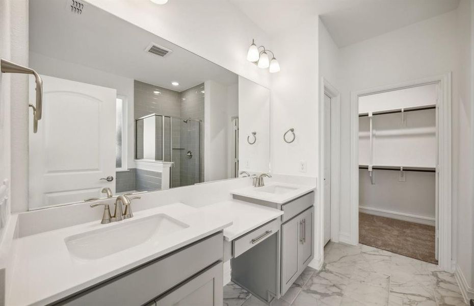 Spacious owner's bathroom with dual vanity and oversized shower *real home pictured