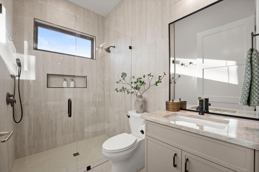 Bathroom featuring vanity and a shower stall