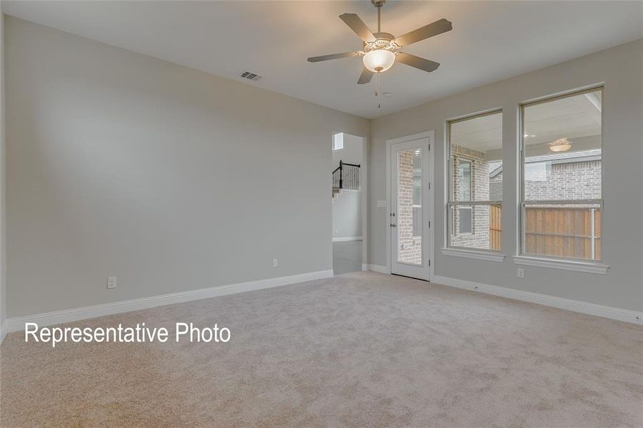 Carpeted empty room featuring ceiling fan