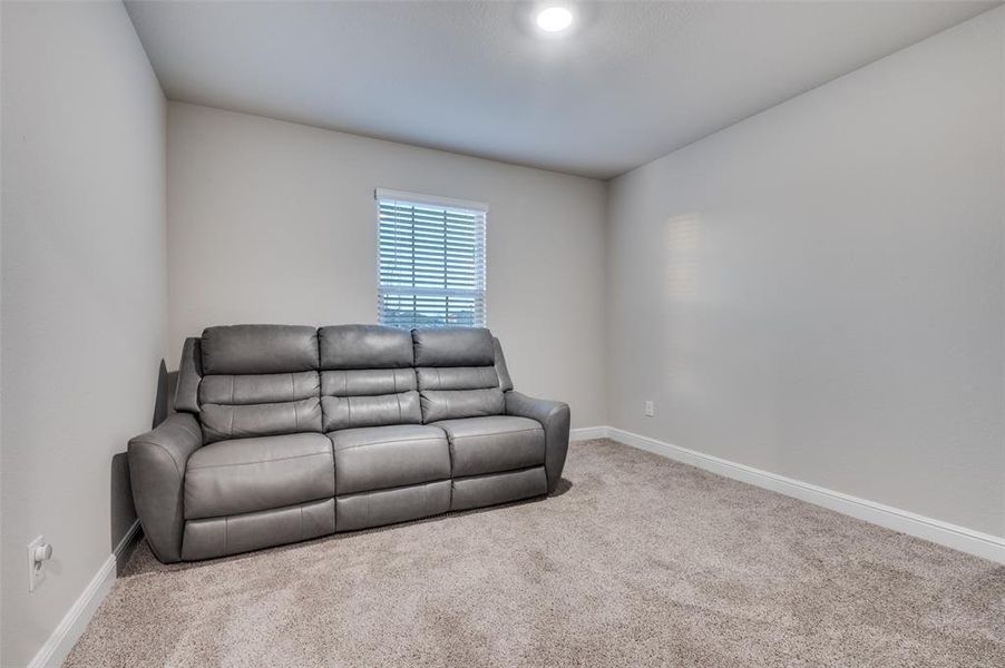Sitting room featuring baseboards and carpet flooring
