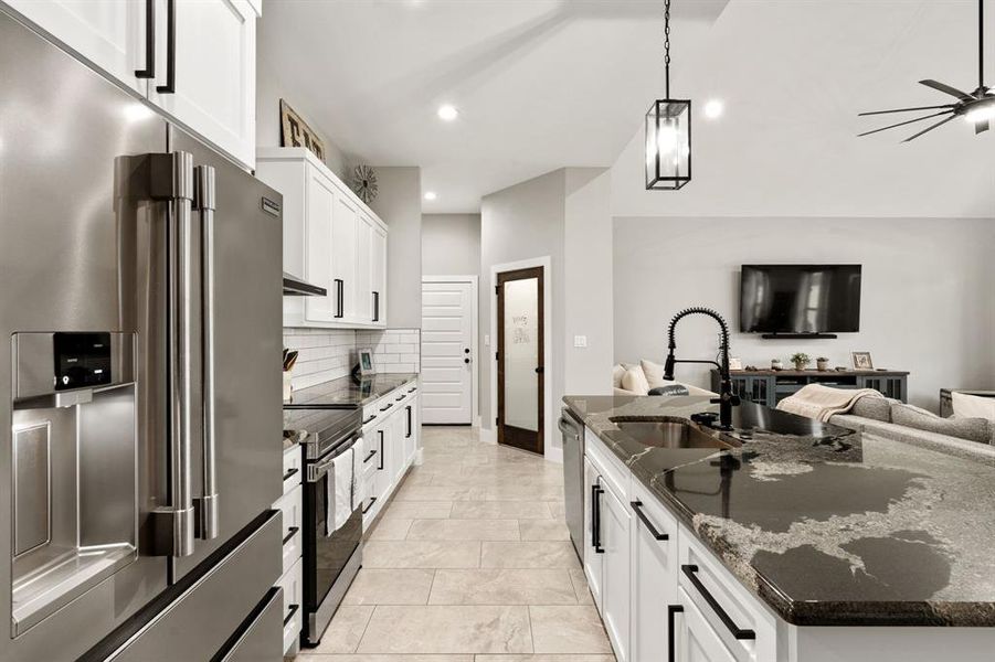 Kitchen has large walk in pantry with decorative frosted glass door.