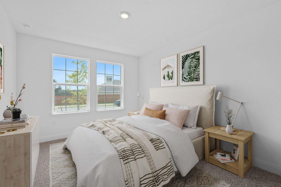 Bedroom featuring carpet floors and baseboards Bedroom featuring carpet floors and baseboards