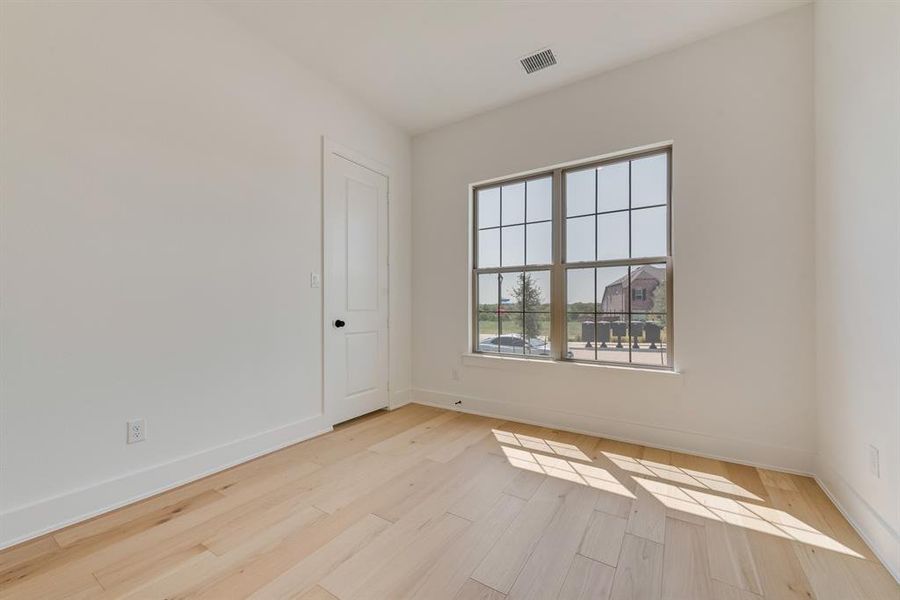 Empty room with baseboards and light wood finished floors