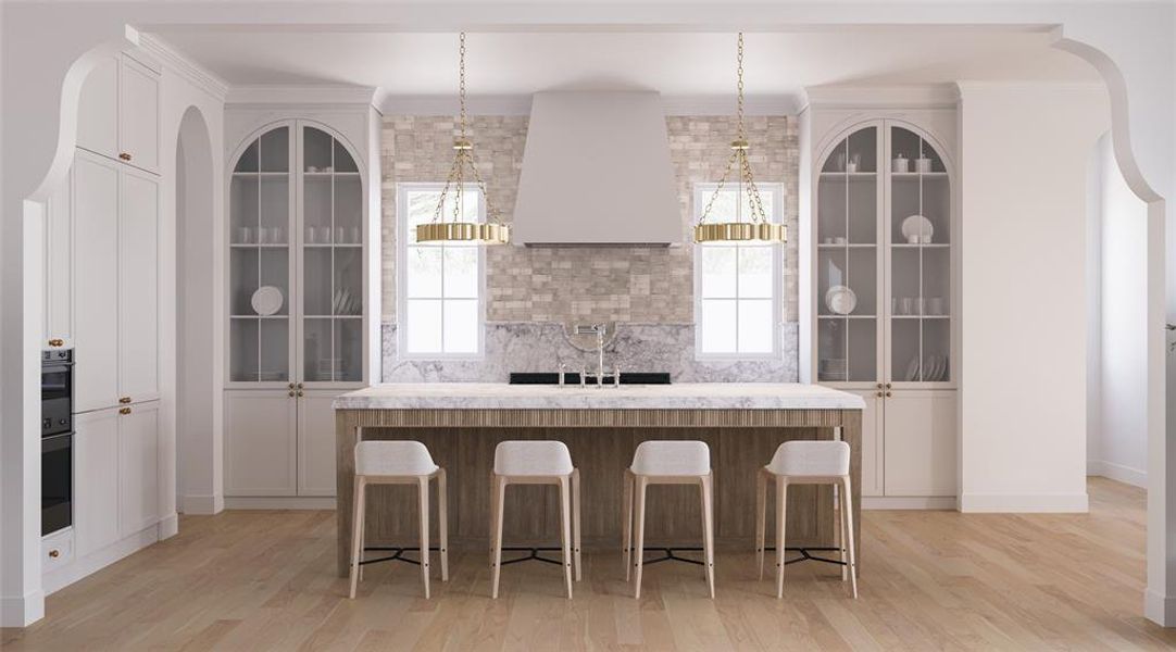 Kitchen with arched walkways, glass insert cabinets, a kitchen bar, and white cabinetry