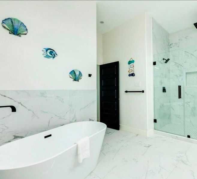 Soaking tub & large walk-in shower in the primary bathroom