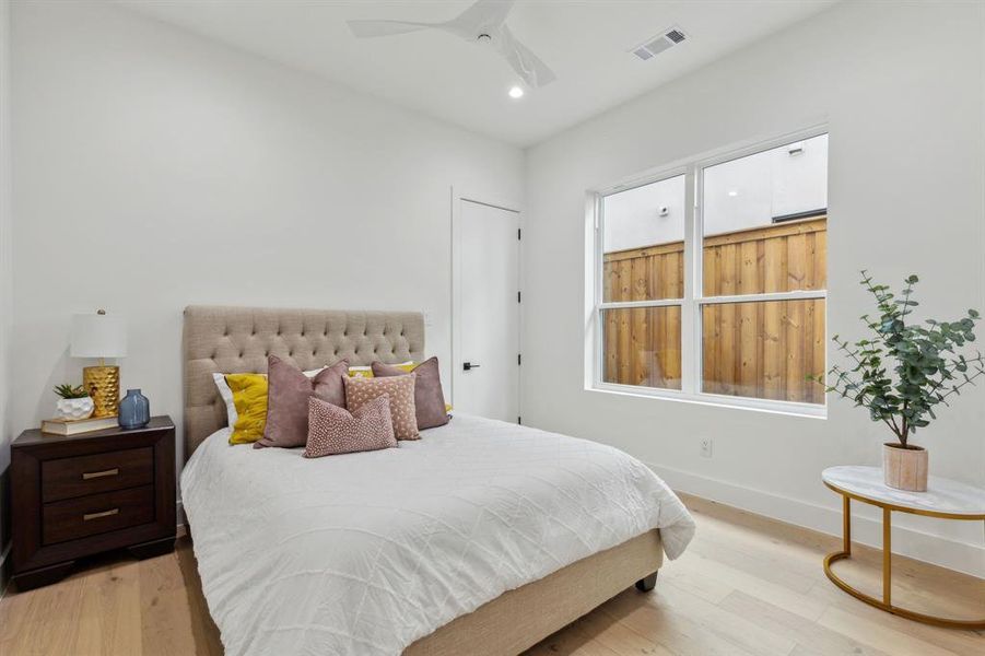 Bedroom featuring ceiling fan and light hardwood / wood-style flooring