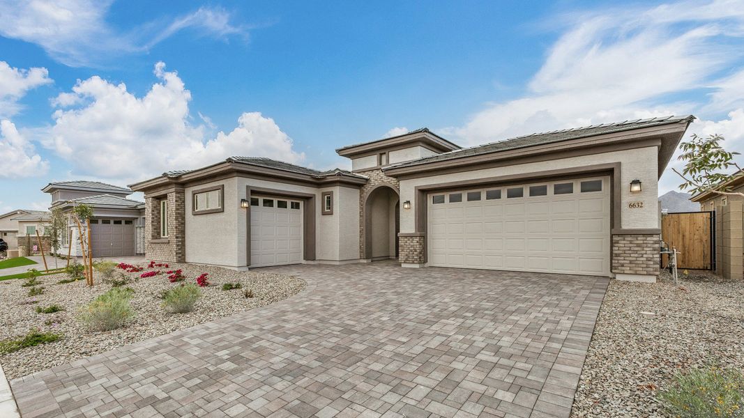 Front exterior of a new home in Windrose, Waddell, AZ, highlighting curb appeal (Image 2). Front exterior of a new home in Windrose, Waddell, AZ, highlighting curb appeal (Image 2).