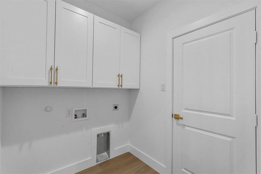 Washroom with cabinet space, electric dryer hookup, dark wood-style floors, hookup for a washing machine, and gas dryer hookup Washroom with cabinet space, electric dryer hookup, dark wood-style floors, hookup for a washing machine, and gas dryer hookup