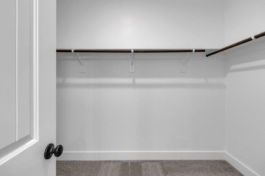 The large stylish walk-in closet adjacent to the primary bath provides ample storage for your wardrobe and a little extra room for those cherished items.