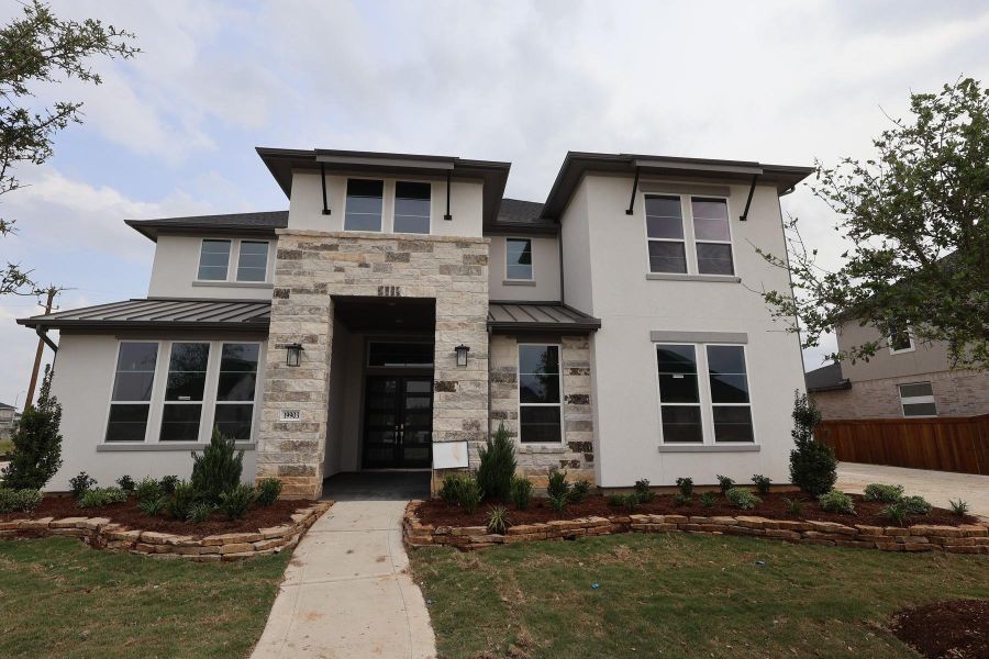 Front exterior of a new home in Dunham Pointe, Cypress, TX, highlighting curb appeal (Image 13).