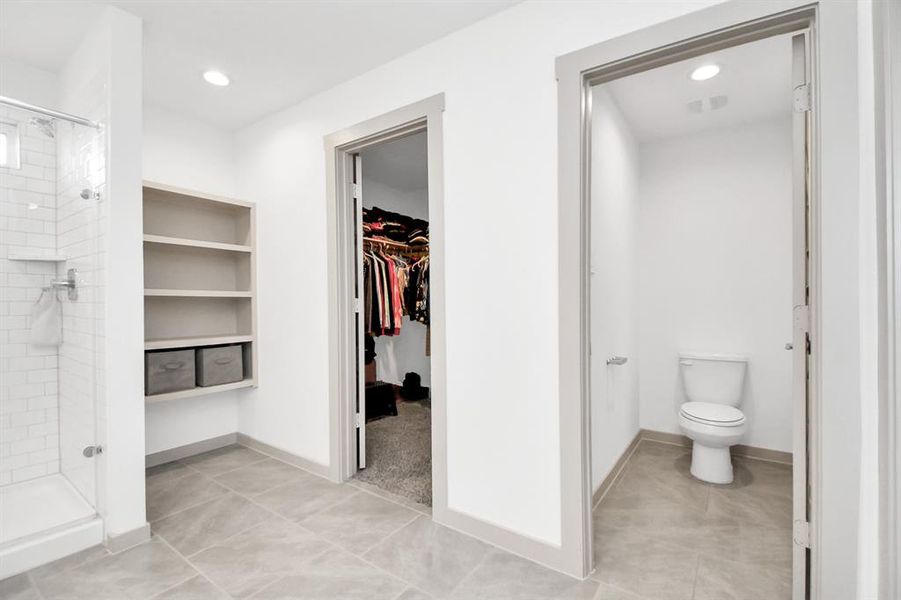 Primary bathroom with built in shelves for storage