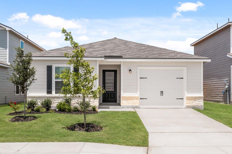 Single story home with a shingled roof, a front yard, and concrete driveway