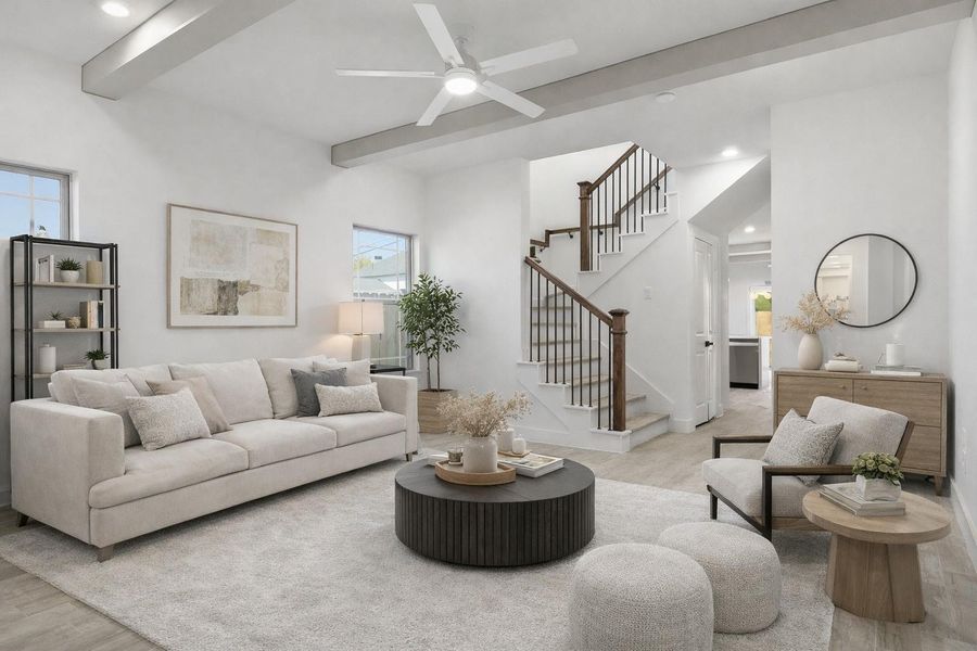 The living room features two large windows, a ceiling fan, stylish beams, and luxury vinyl flooring. (staged)