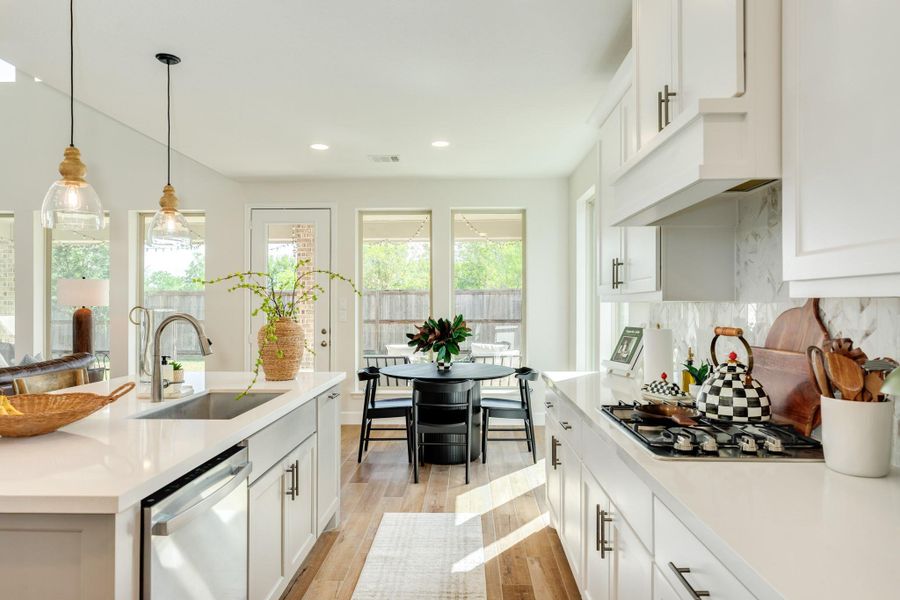 Modern breakfast bar featuring a premium farmhouse-style stainless steel sink and a gas range top, truly a chef's dream. Modern breakfast bar featuring a premium farmhouse-style stainless steel sink and a gas range top, truly a chef's dream.