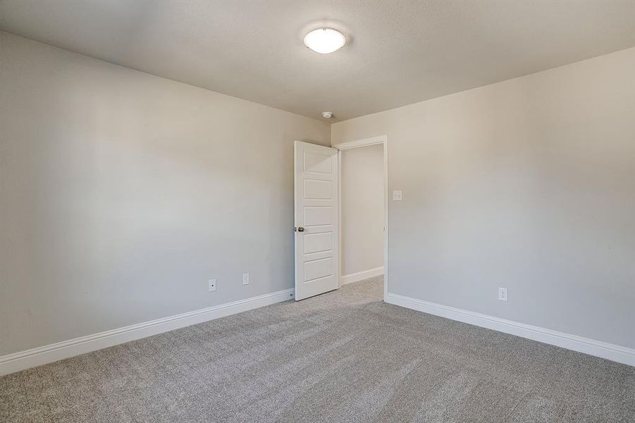 Unfurnished room featuring baseboards and light colored carpet Unfurnished room featuring baseboards and light colored carpet