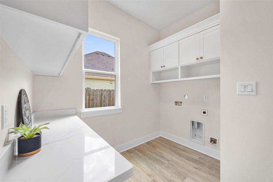 Laundry Room Offers Storage and Counter Space.