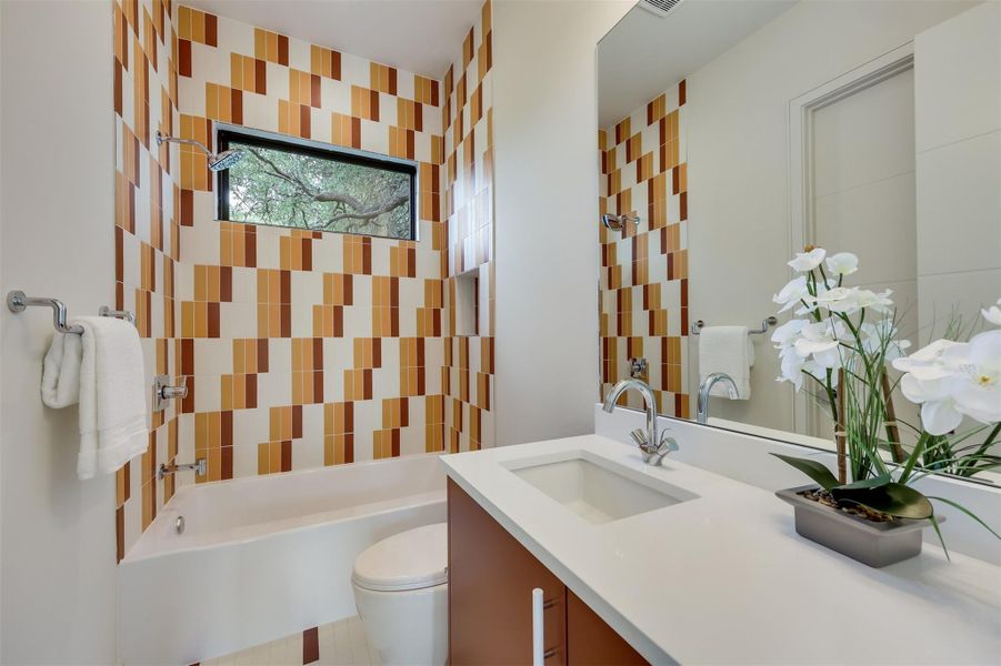Every bathroom has its own soul, featuring custom Dal Tile designs that make even the guest quarters feel like a boutique hotel