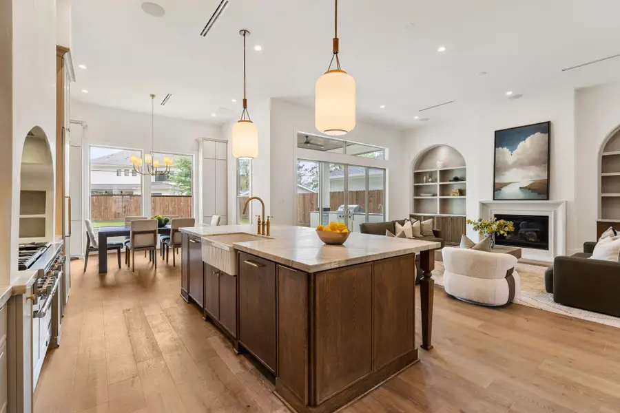 From this perspective, the kitchen reveals its thoughtful layout, featuring extensive cabinetry, high-end appliances, and a large island that anchors the space. The open design allows for effortless entertaining and everyday living.