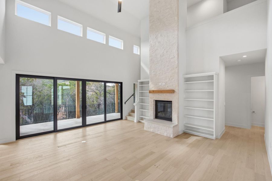 Light filled family room with limestone fireplace and clerestory windows