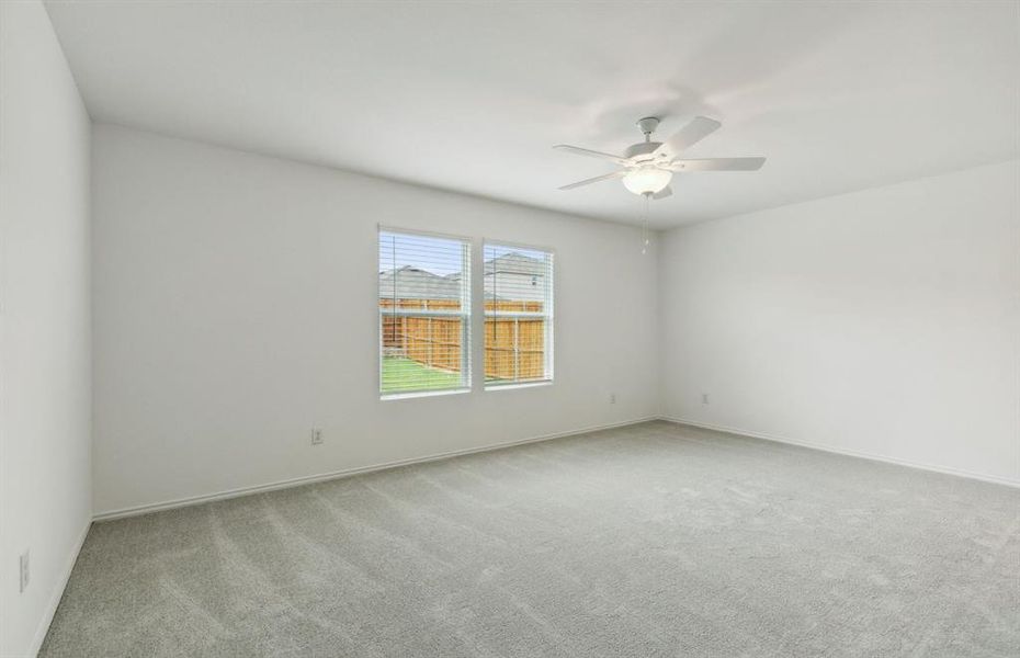 Spacious owner's suite with large windows *real home pictured