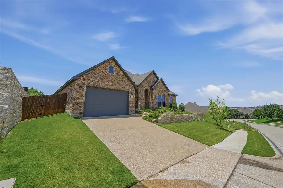 Front exterior of a new home in , Benbrook, TX, highlighting curb appeal (Image 20). Front exterior of a new home in , Benbrook, TX, highlighting curb appeal (Image 20).