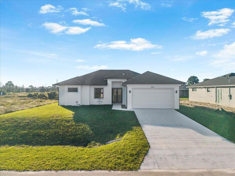 Front exterior of a new home in , Lehigh Acres, FL, highlighting curb appeal (Image 2). Front exterior of a new home in , Lehigh Acres, FL, highlighting curb appeal (Image 2).