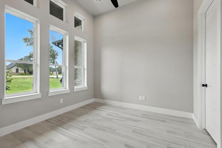 Unfurnished room featuring light wood-style floors and ceiling fan Unfurnished room featuring light wood-style floors and ceiling fan