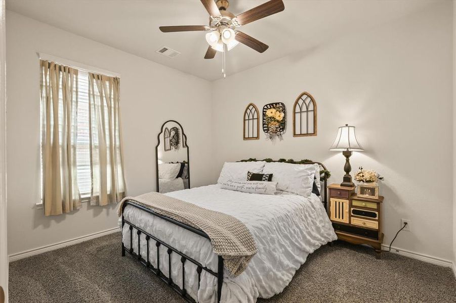 Bedroom with carpet floors and ceiling fan Bedroom with carpet floors and ceiling fan