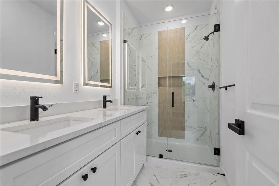 Primary bath showcases high-end finishes and a contemporary design for a polished, spa-like feel Primary bath showcases high-end finishes and a contemporary design for a polished, spa-like feel