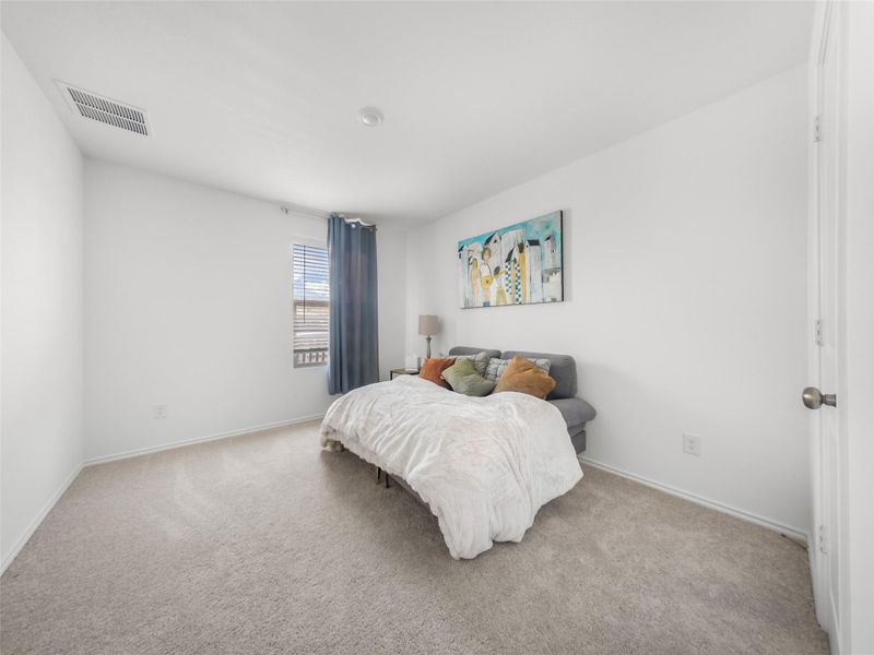 Bedroom with light colored carpet