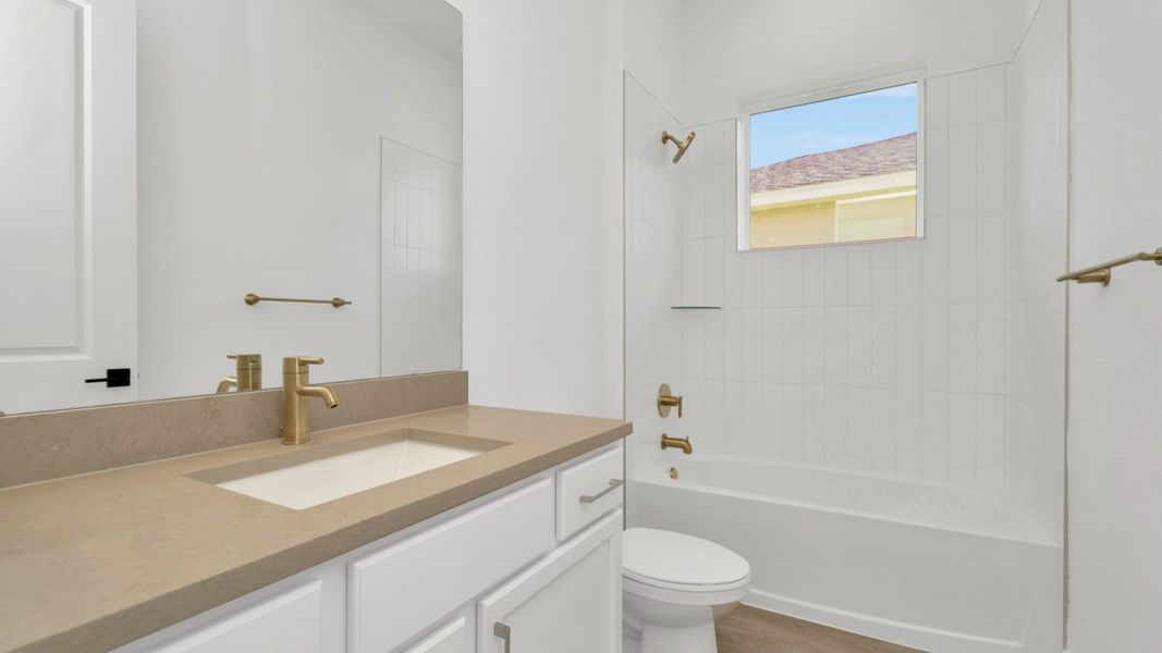 The Second Bathroom of a DRB Homes Grand Hawk which is offered as a home plan at Serengeti in Spring Hill, FL.