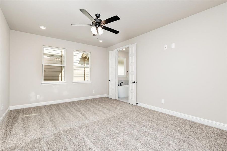 Carpeted spare room with ceiling fan and recessed lighting