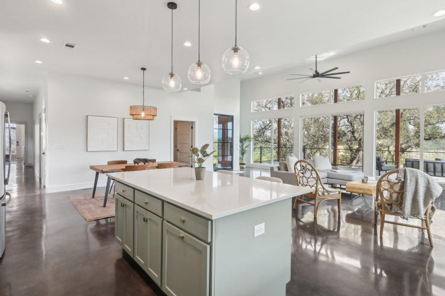 Kitchen featuring recessed lighting, concrete flooring, a ceiling fan, baseboards, and a center island Kitchen featuring recessed lighting, concrete flooring, a ceiling fan, baseboards, and a center island