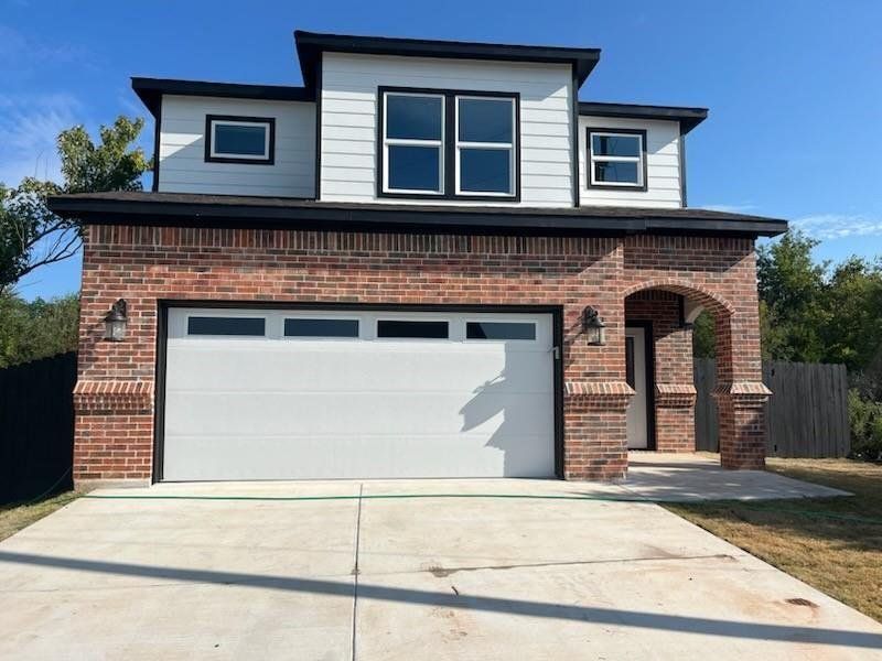 View of front of home with brick siding, concrete driveway, an attached garage, and covered porch View of front of home with brick siding, concrete driveway, an attached garage, and covered porch