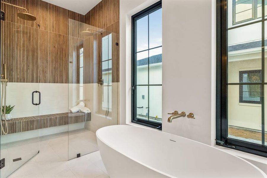 Bathroom with a freestanding tub, a stall shower, and tile patterned flooring Bathroom with a freestanding tub, a stall shower, and tile patterned flooring