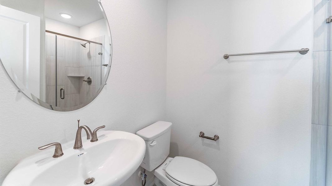 Full bath with toilet and a stall shower