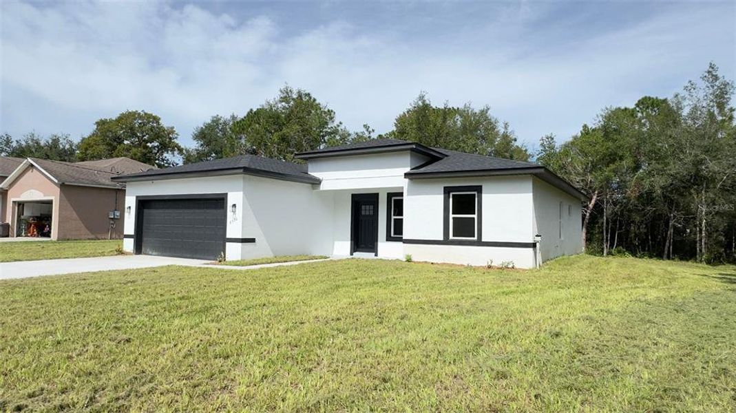 Front exterior of a new home in , Citrus Springs, FL, highlighting curb appeal (Image 13).