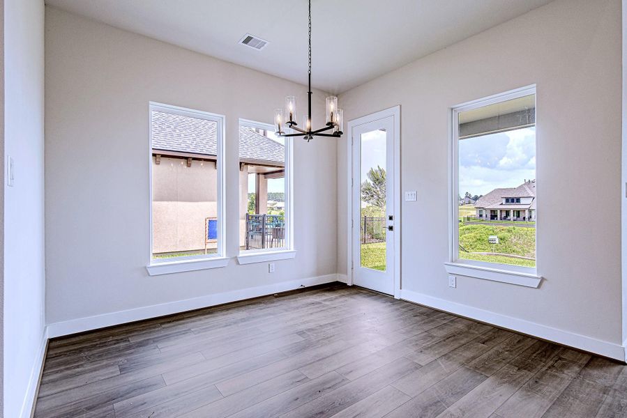 Dining area filled with natural light and backyard views Dining area filled with natural light and backyard views